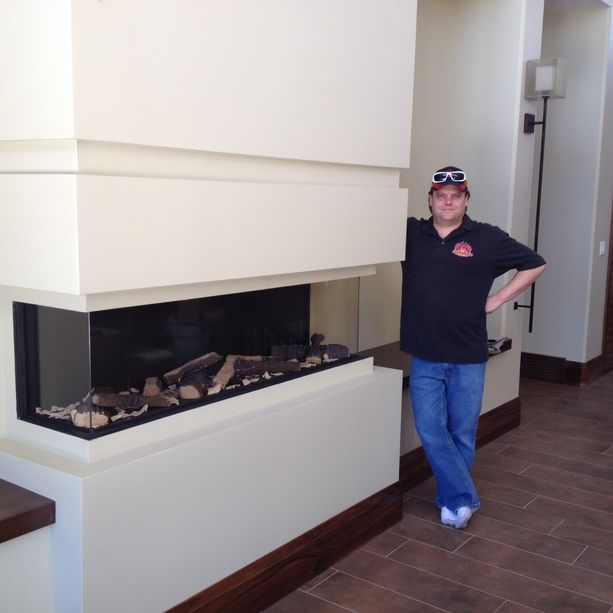 man standing near gas fire 